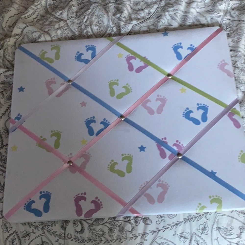 Bulletin board with baby feet on it